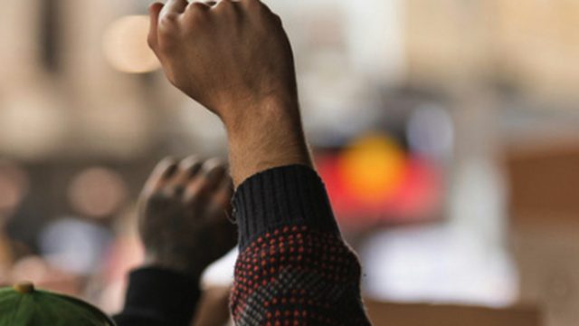 Raised fist at a community gathering